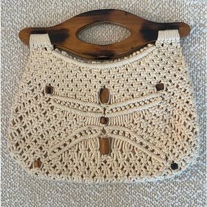 Crochet purse. Cream color with some wooden beads on one side.